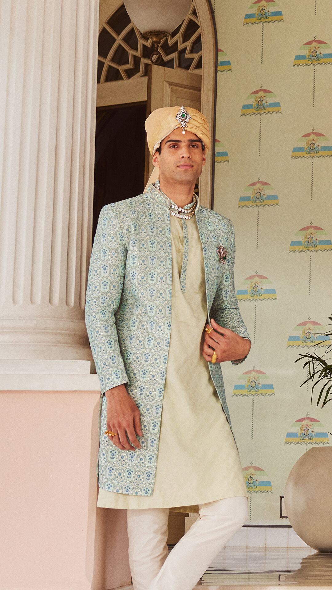 men wearing golden and white Rajputi safas for a traditional Indian wedding celebration